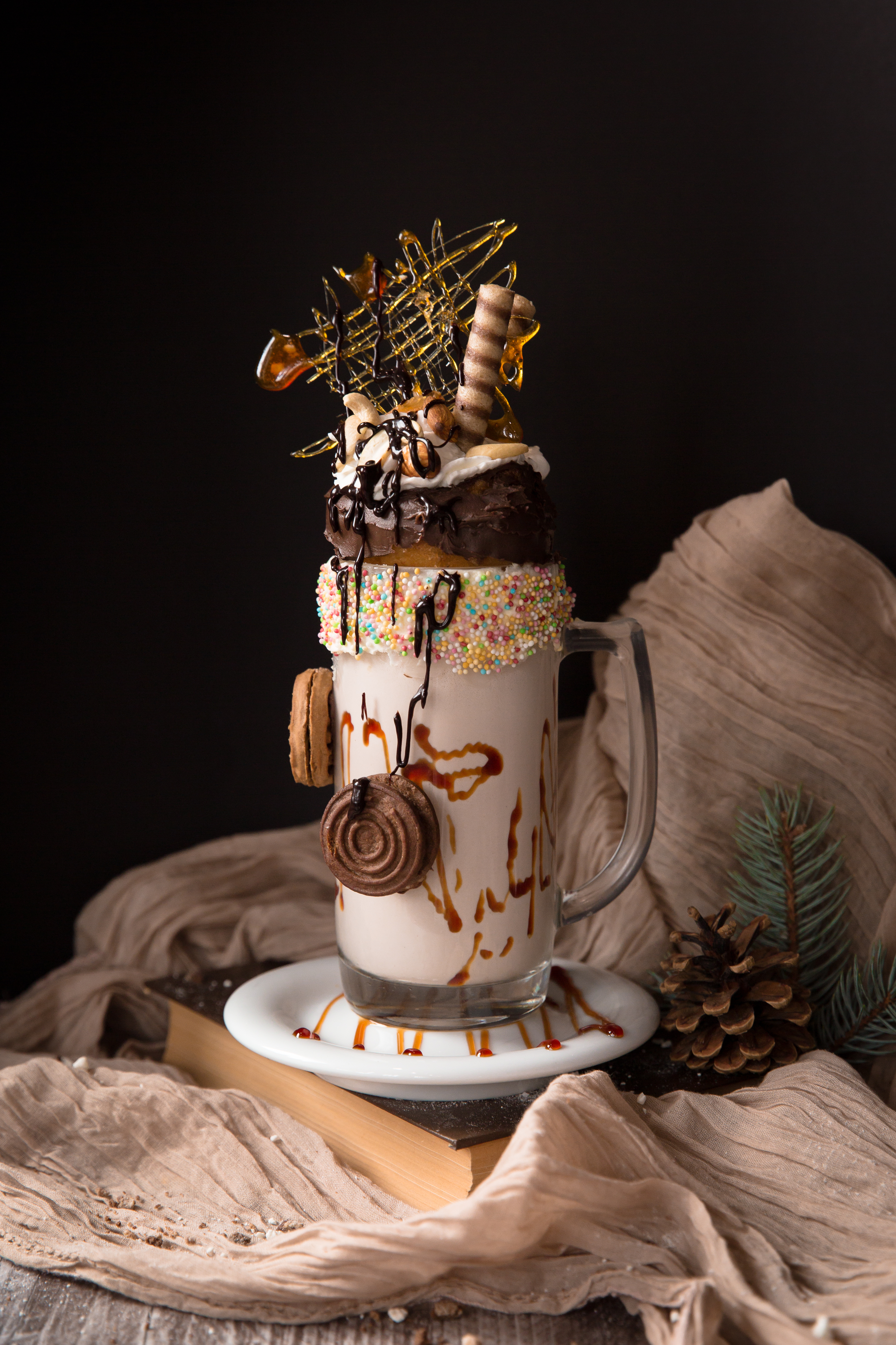 Giant monster caramel milk shake with whipped cream, cookies, nuts